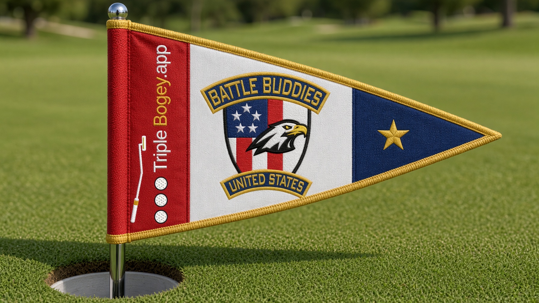 Embroidered triangular golf pin flag on a green. Red hoist with Triple Bogey.app, white center with Battle Buddies USA, navy tip.